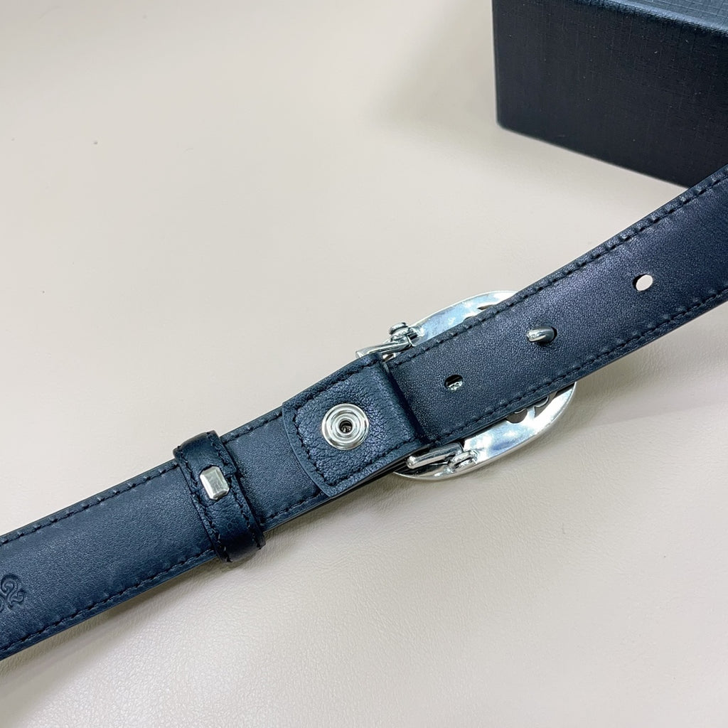 Chrome belt close-up of adjustment end: dark blue leather with silver hardware and rivets