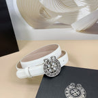 Light-colored belt with round silver floral buckle, adjustable strap holes, loop end