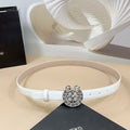 White belt with round floral silver buckle and adjustable eyelet holes