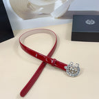 Chrome belt with red glossy strap and silver-tone circular buckle, angled view