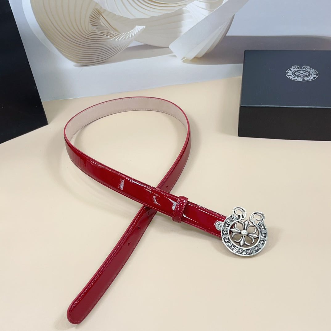 Chrome belt with red glossy strap and silver-tone circular buckle, angled view