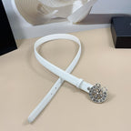 White belt with long strap and round silver floral buckle