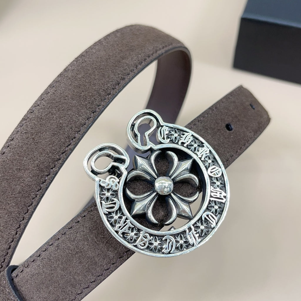 Dark brown belt close-up with large silver floral buckle centerpiece