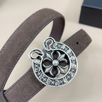 Dark brown belt close-up with large silver floral buckle centerpiece