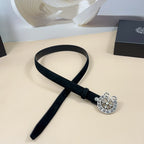 Chrome belt with dark strap and silver circular floral buckle with adjustable holes