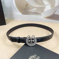 Black leather belt with silver-tone floral heart buckle and eyelet holes