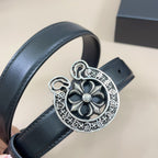 Dark leather belt with large silver-tone round heart buckle and floral motif