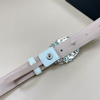 Belt clasp and strap keeper in silver-tone hardware on light blue leather belt