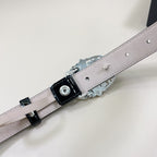 Chrome belt with light gray strap, silver buckle hardware and snap holes