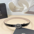 Chrome belt with black patent strap and ornate silver-tone floral buckle