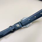 Chrome belt end view with dark leather buckle loop and metal holes detail