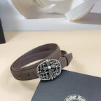 Chrome belt, dark brown strap with ornate silver-toned round buckle and studded edge