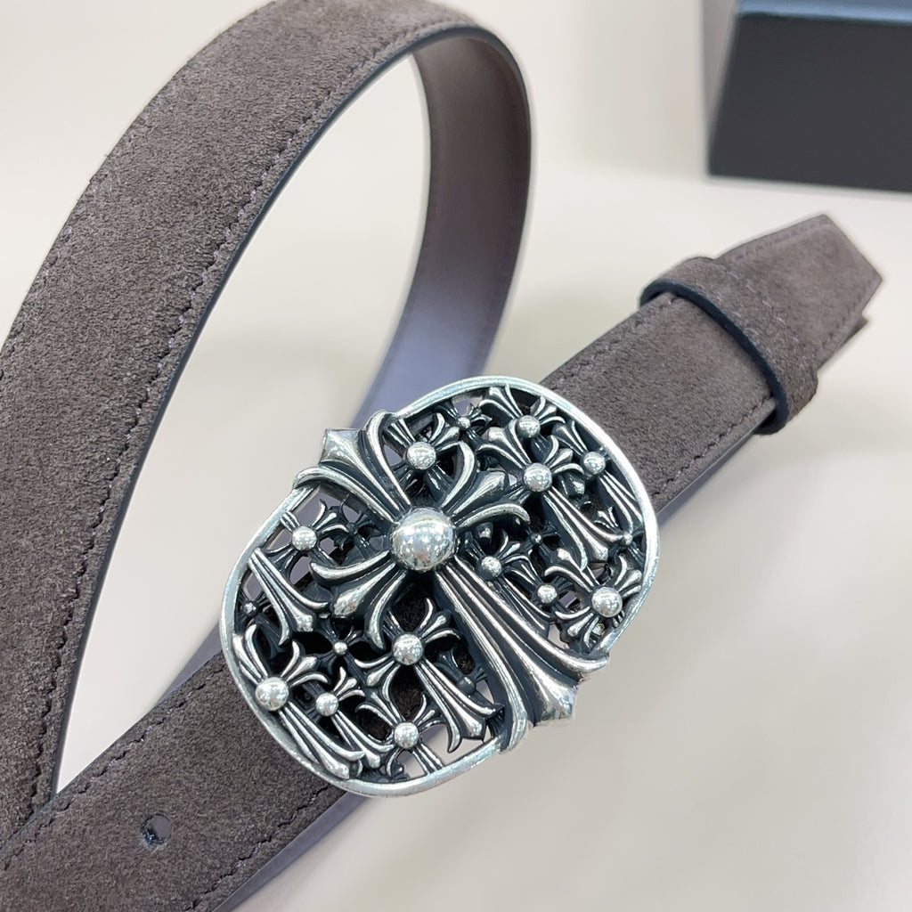 Chrome belt close-up: dark suede strap with large chrome-look floral buckle
