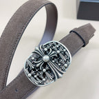 Chrome belt close-up: dark suede strap with large chrome-look floral buckle