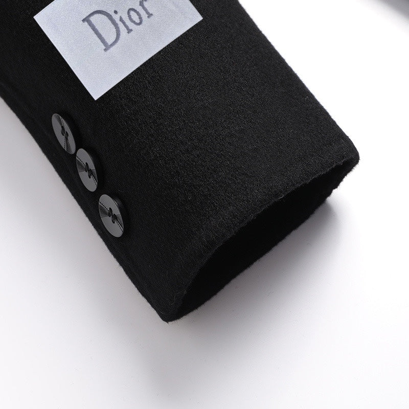 Coat cuff area with button detail and Dior-branded size tag, dark fabric