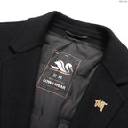Coat chest logo patch and buttoned pocket flap on dark fabric