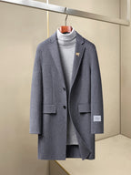 Long coat with notch lapels, single-button front, chest and hip pockets, dark blue-gray