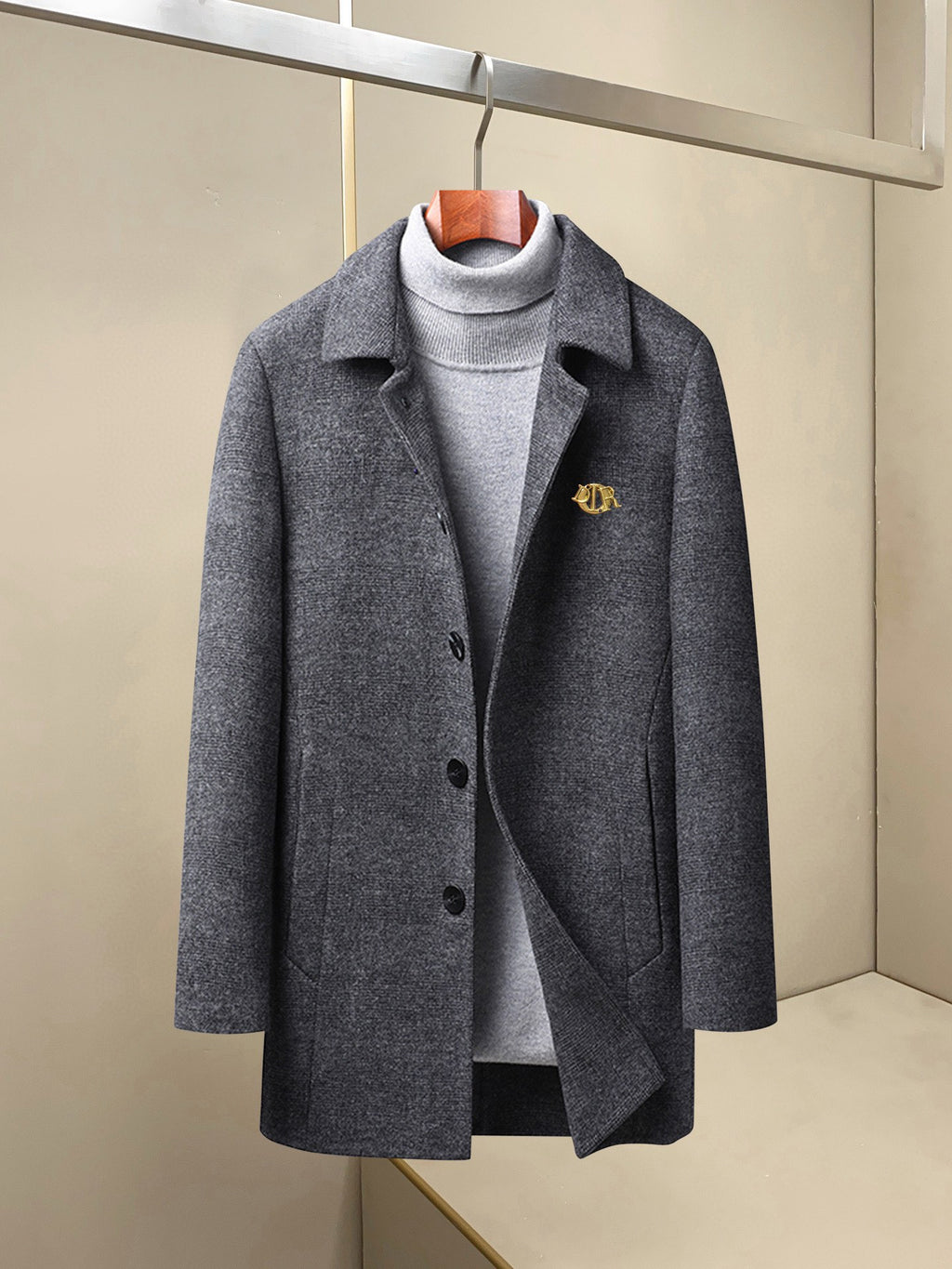 Charcoal long coat with notch lapels, button front, and small chest logo pin