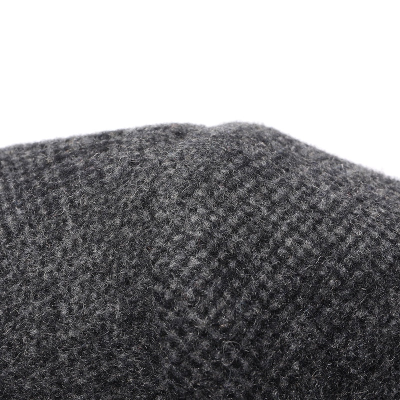 Charcoal tweed-style wool coat fabric close-up