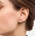 Bell stud earrings in silver tone with pavé detailing, worn on ear