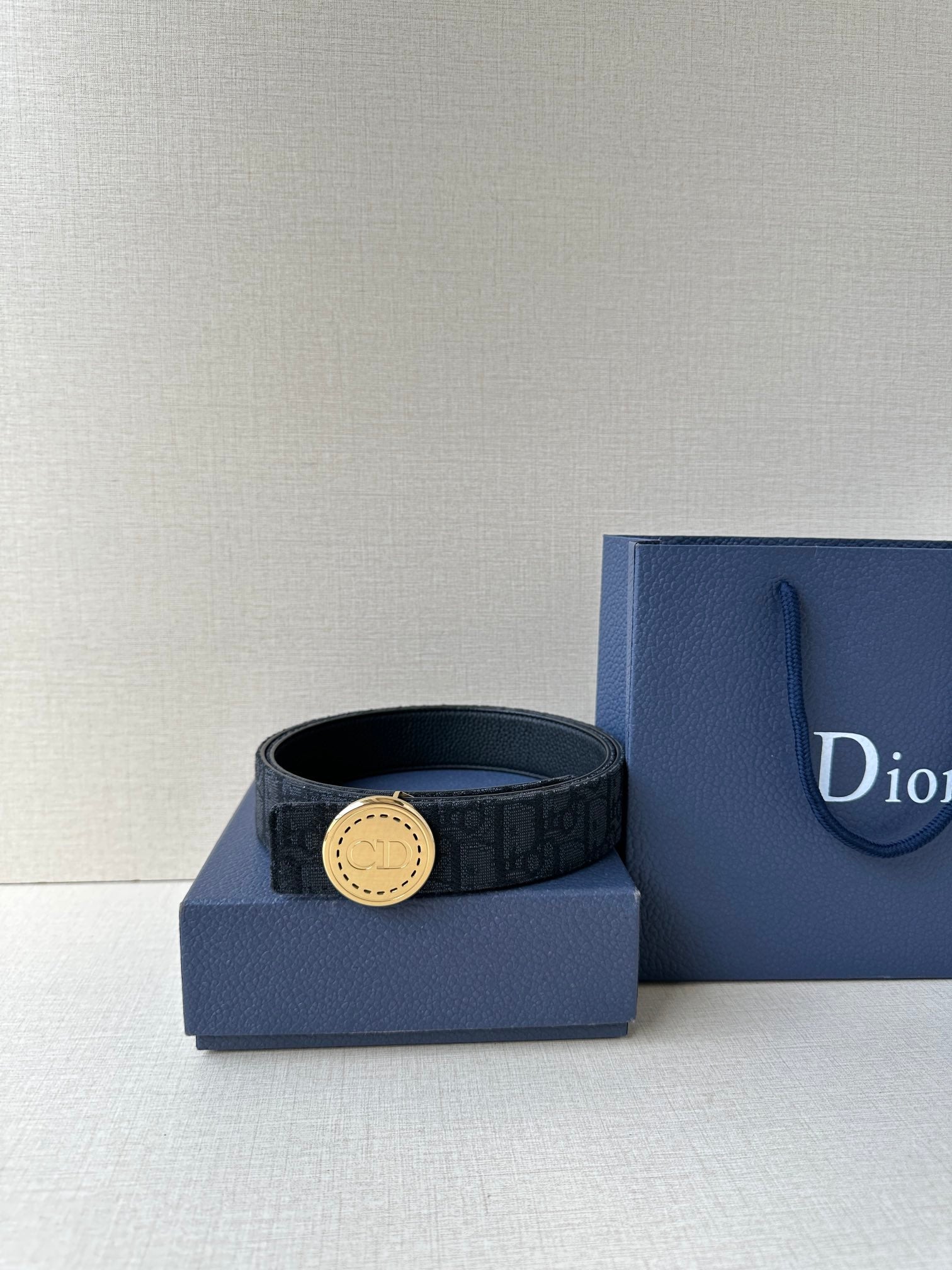 Dior belt with dark monogram strap and gold-tone round buckle