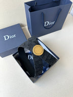 Dior belt in box with dark monogram strap and gold-tone round buckle