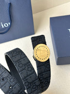 Dior belt detail with dark monogram strap and gold-tone round buckle