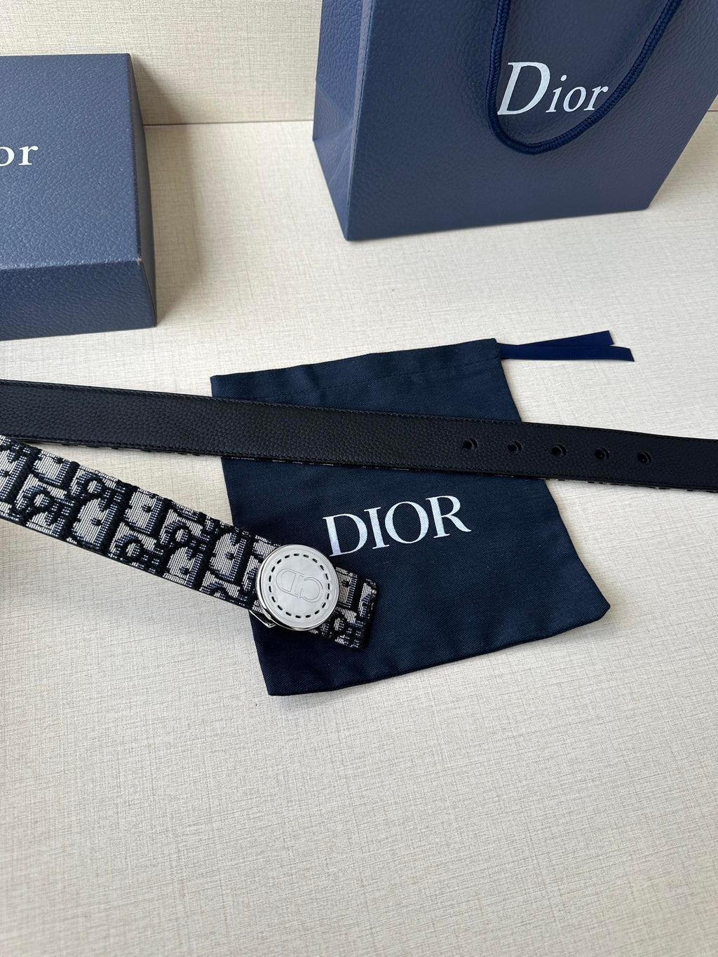 Logo-print belt with round light buckle, patterned webbing strap laid flat