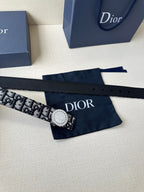 Logo-print belt with round light buckle, patterned webbing strap laid flat