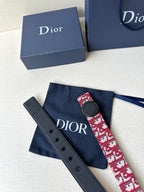Dior belt and matching navy strap segment; red-and-white monogram with dark round buckle