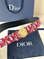 Dior belt close-up: red-and-white pattern strap with gold circular buckle and black trim