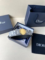 Dior belt in box with monogram strap and round gold-tone logo buckle