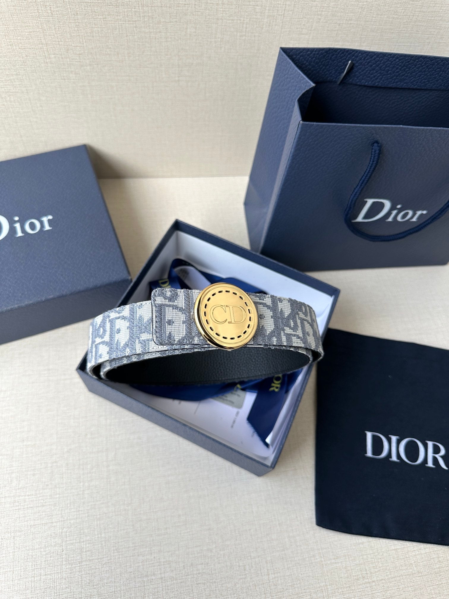 Dior belt in box with monogram strap and round gold-tone logo buckle