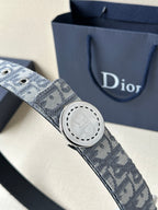 Dior belt close-up with monogram fabric and round engraved buckle