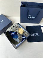 Dior belt in a gift box with monogram strap and round gold-toned buckle.