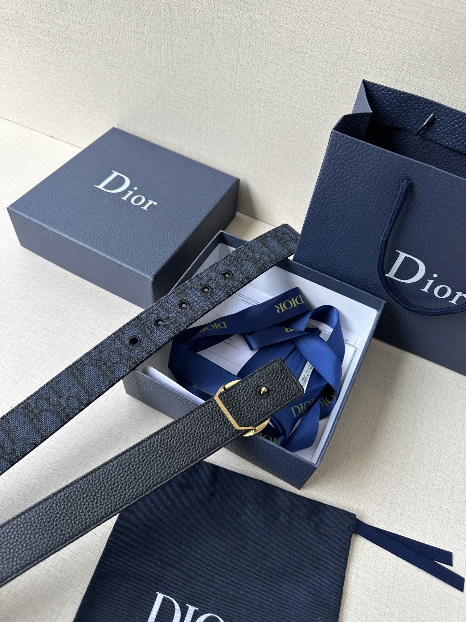 Navy Dior belt with gold-tone buckle and monogram strap in a box set