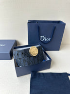 Navy Dior belt with round gold logo buckle in a blue box