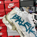 White high-top sneaker with blue graffiti logo, padded collar and laces