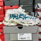 White high-top sneaker with blue graffiti graphic, thick sole and lace-up