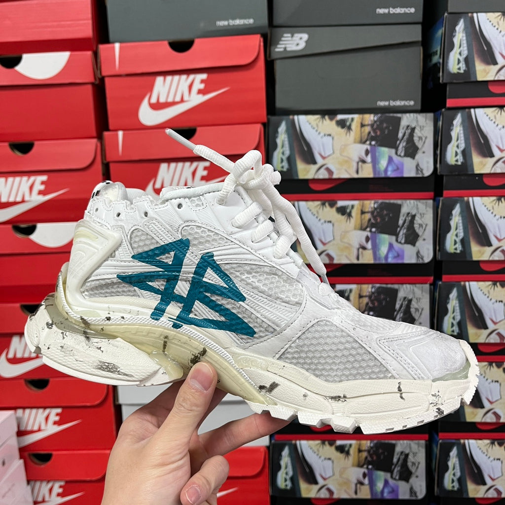 White high-top sneaker with blue graffiti logo and lace-up front view