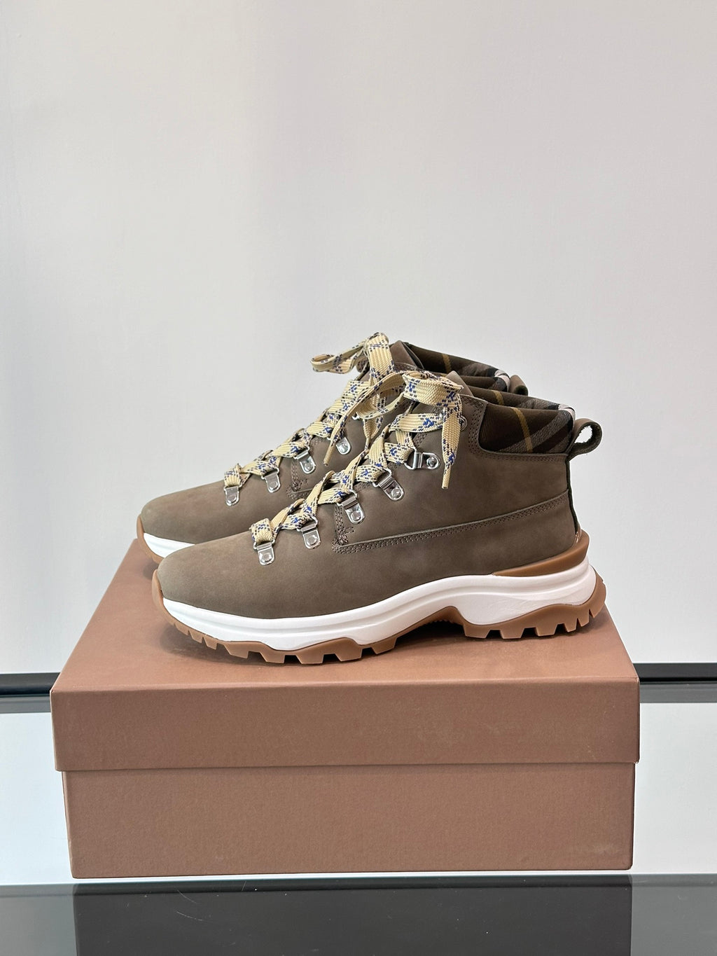 Burberry mid-top lace-up boot with check ribbon laces and chunky white tread sole