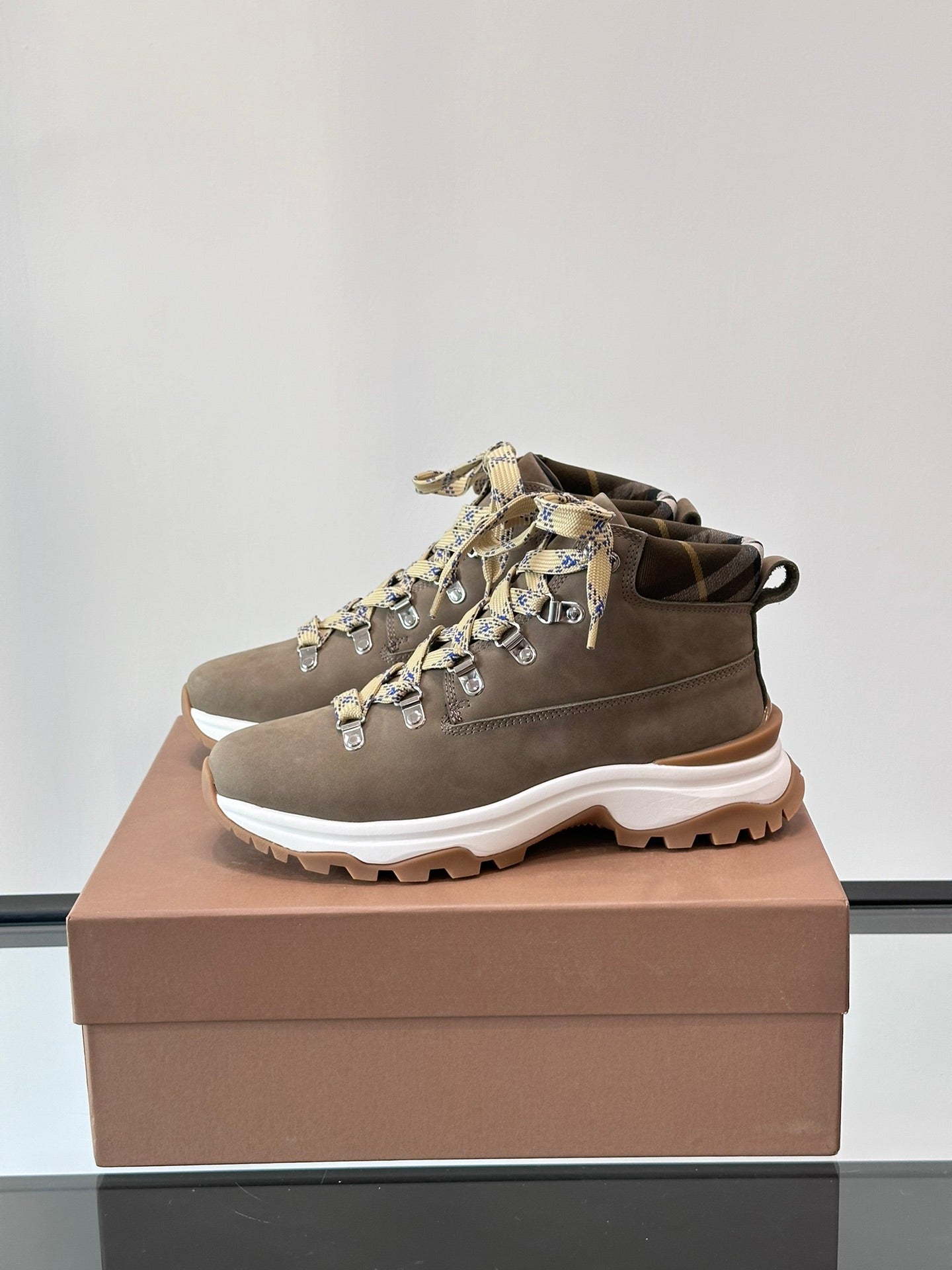 Burberry mid-top lace-up boot with check ribbon laces and chunky white tread sole