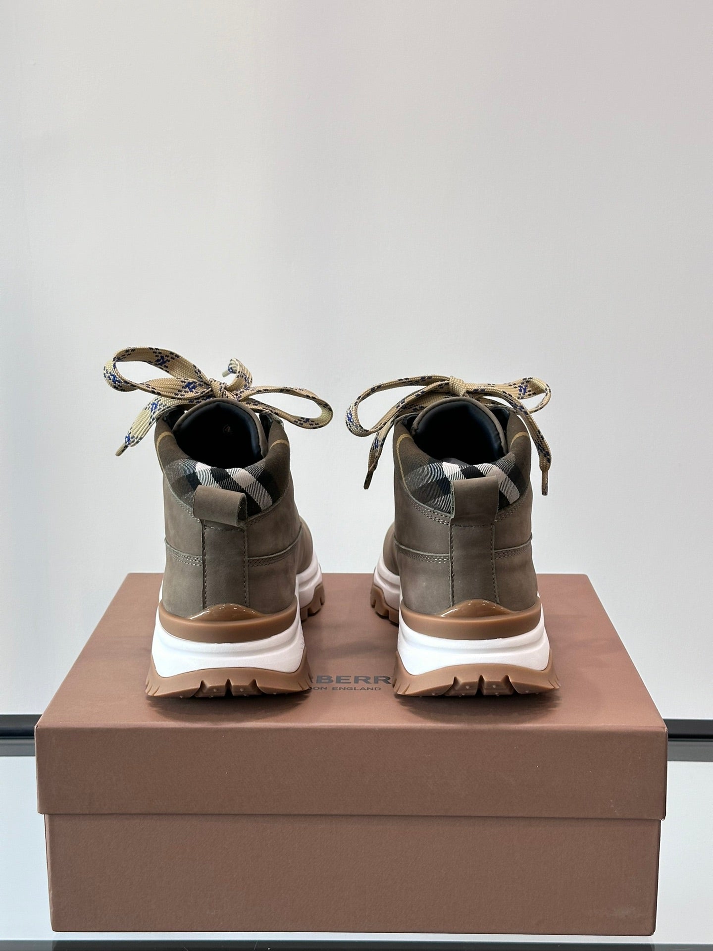 Burberry lace-up boots with check ribbon ties, dark taupe suede backs, chunky white midsoles