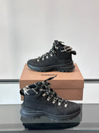 Black suede-style lace-up boot with plaid collar and contrast-pattern laces