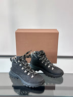 Black high-top lace-up boots with plaid-lined collar and thick outsole