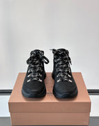 Pair of black high-top lace-up boots with plaid lining and silver-tone eyelets