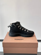 Black high-top lace-up boot with plaid-lined collar and silver lace hardware