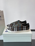 Plaid low-top sneakers on box, lace-up design with black trim and blue accents