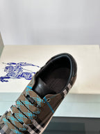 Plaid low-top sneaker close-up at heel, black trim and blue lace accents