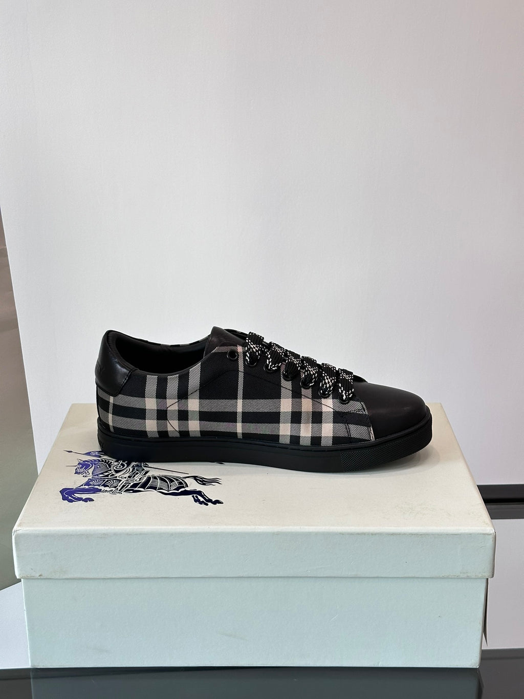 Burberry black lace-up sneakers with check panel detail and textured fringe